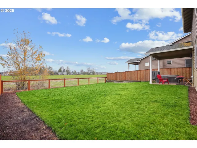 a view of yard with swimming pool and green space