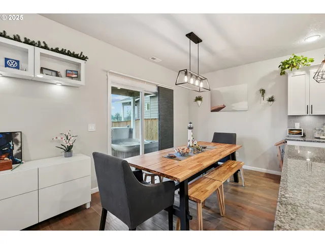 a view of a dining room with furniture and chandelier