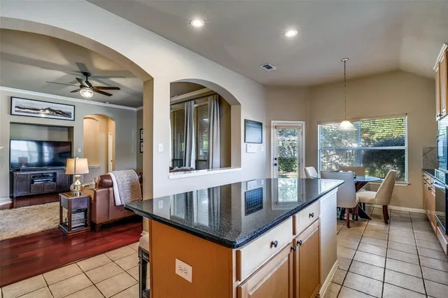 a dining hall with granite countertop a large window and stainless steel appliances