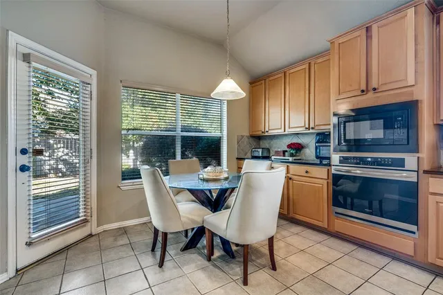 a kitchen with granite countertop a stove a sink and a microwave