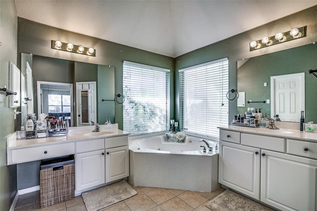 4317 Founders Drive Rowlett, TX 75089 - Photo 16 of 25 a large white bathroom with a large tub sink and mirror