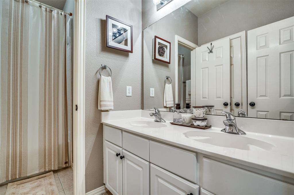4317 Founders Drive Rowlett, TX 75089 - Photo 21 of 25 a bathroom with a double vanity sink and a mirror
