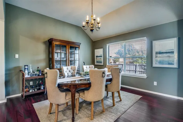 a view of a dining room with furniture wooden floor and chandelier