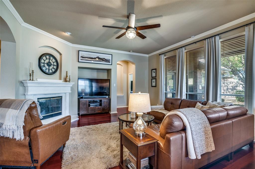 4317 Founders Drive Rowlett, TX 75089 - Photo 7 of 25 a living room with furniture a fireplace and a flat screen tv
