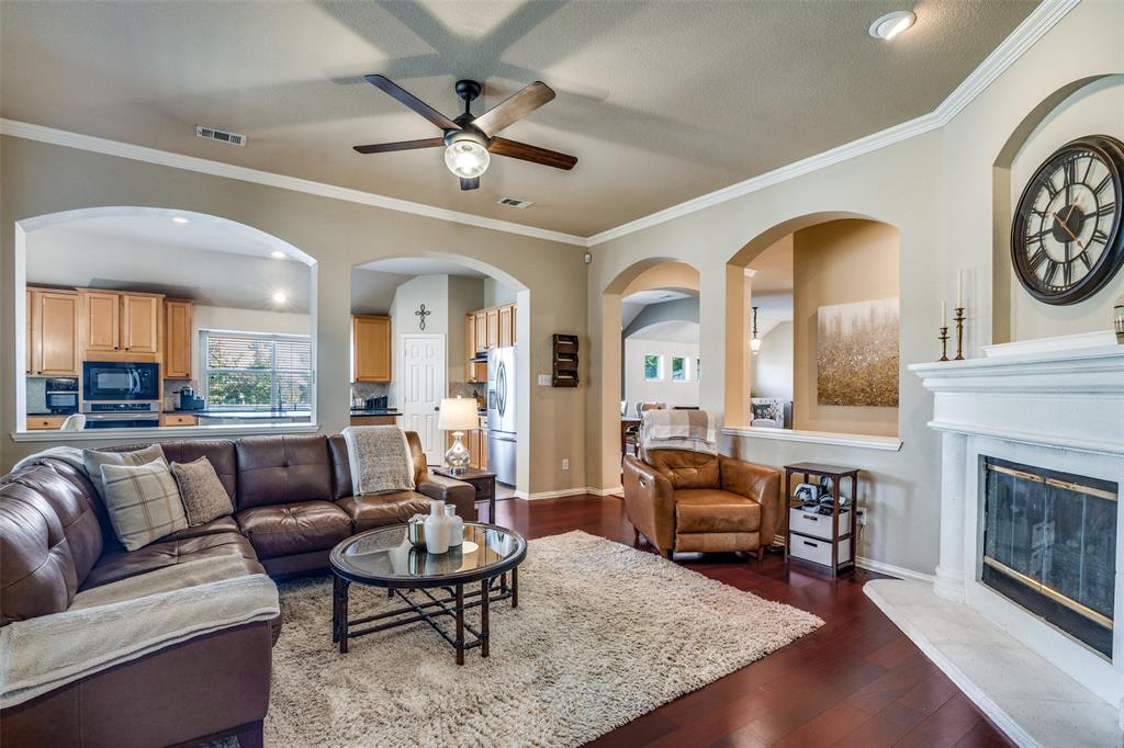 4317 Founders Drive Rowlett, TX 75089 - Photo 8 of 25 a living room with furniture a clock on wall and a fireplace