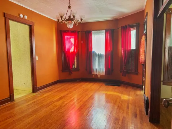 a view of a room with wooden floor and windows