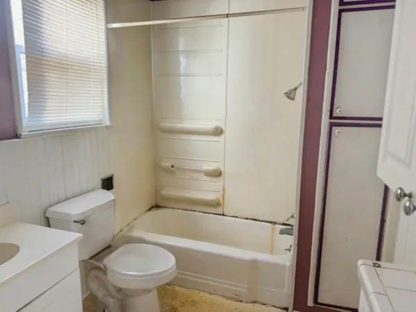 a bathroom with a toilet and a bathtub