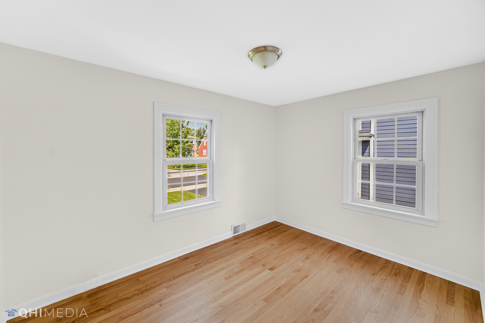 18345 Perth Avenue Homewood, IL 60430 - Photo 11 of 22 an empty room with wooden floor and windows