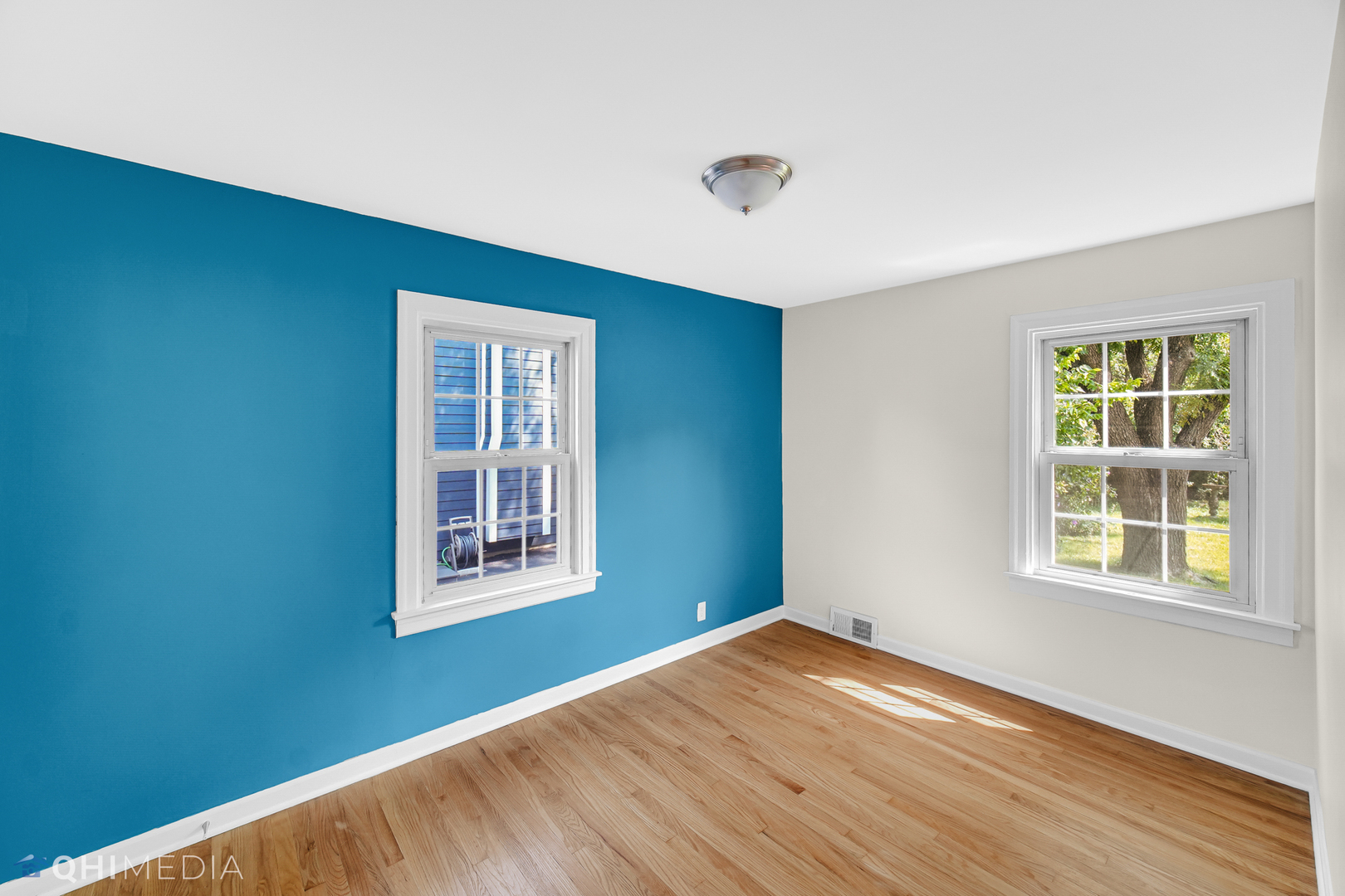 18345 Perth Avenue Homewood, IL 60430 - Photo 12 of 22 an empty room with wooden floor and windows