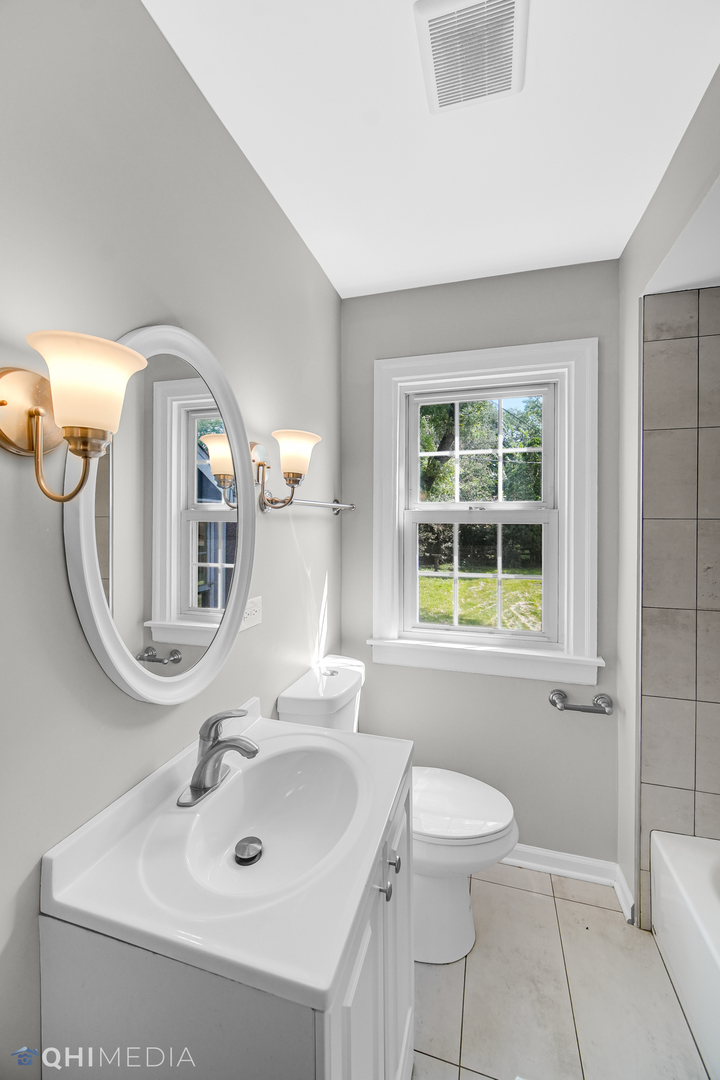 18345 Perth Avenue Homewood, IL 60430 - Photo 13 of 22 a bathroom with a toilet sink and mirror