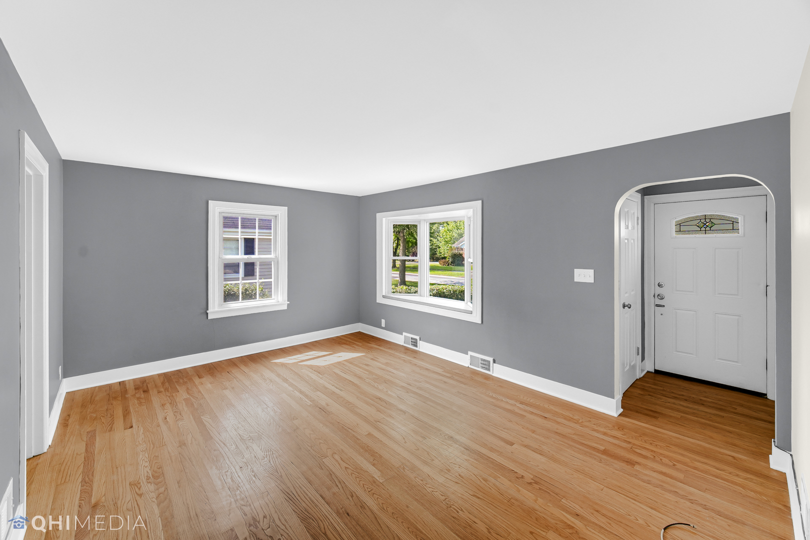 18345 Perth Avenue Homewood, IL 60430 - Photo 4 of 22 an empty room with wooden floor cabinet and windows
