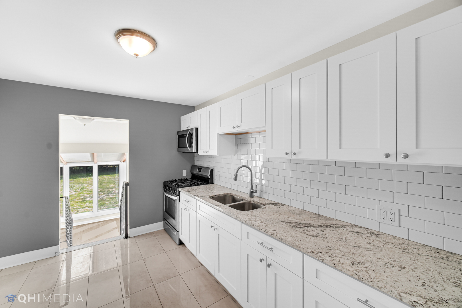 18345 Perth Avenue Homewood, IL 60430 - Photo 7 of 22 a kitchen with stainless steel appliances granite countertop a sink stove and cabinets