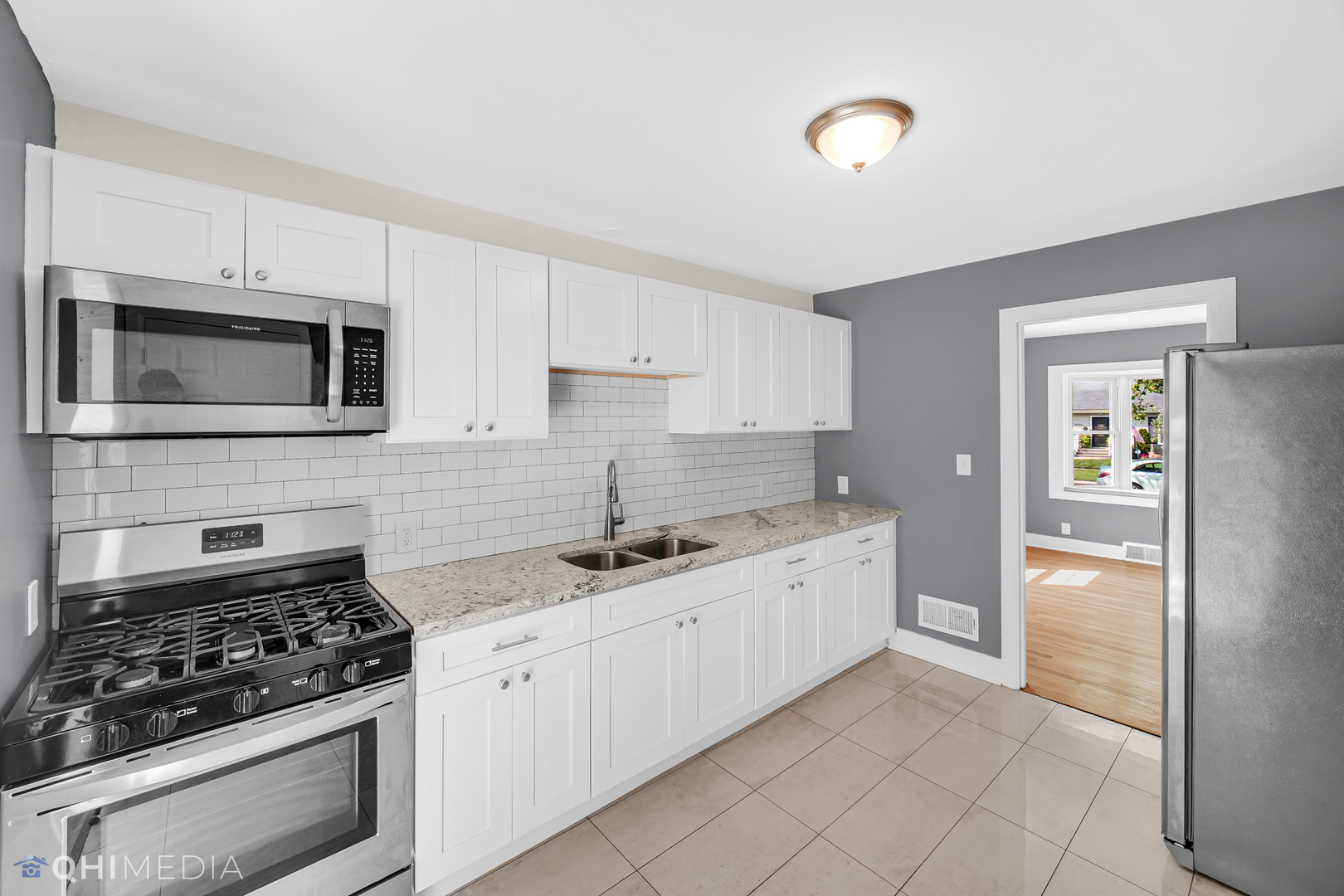 18345 Perth Avenue Homewood, IL 60430 - Photo 8 of 22 a kitchen with stainless steel appliances granite countertop a stove and a refrigerator