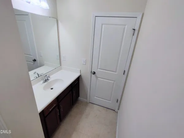 a bathroom with a toilet and a mirror