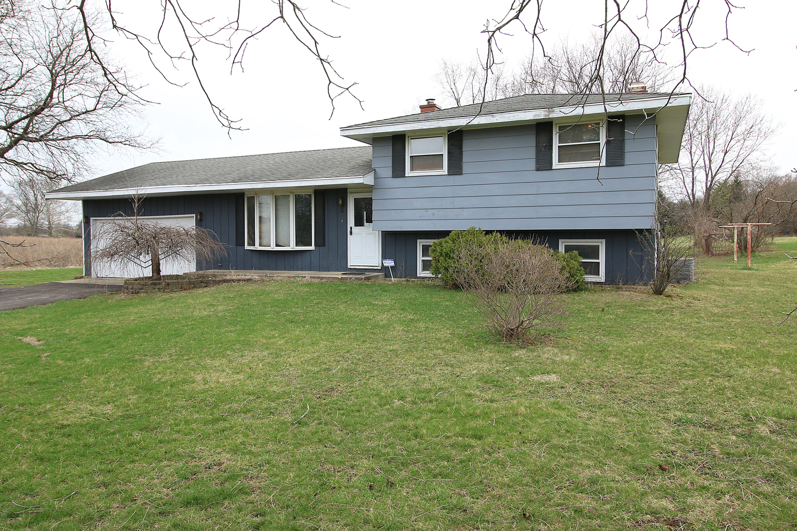1356 Smith Road Lockport, IL 60441 - Photo 1 of 20 a front view of a house with a garden