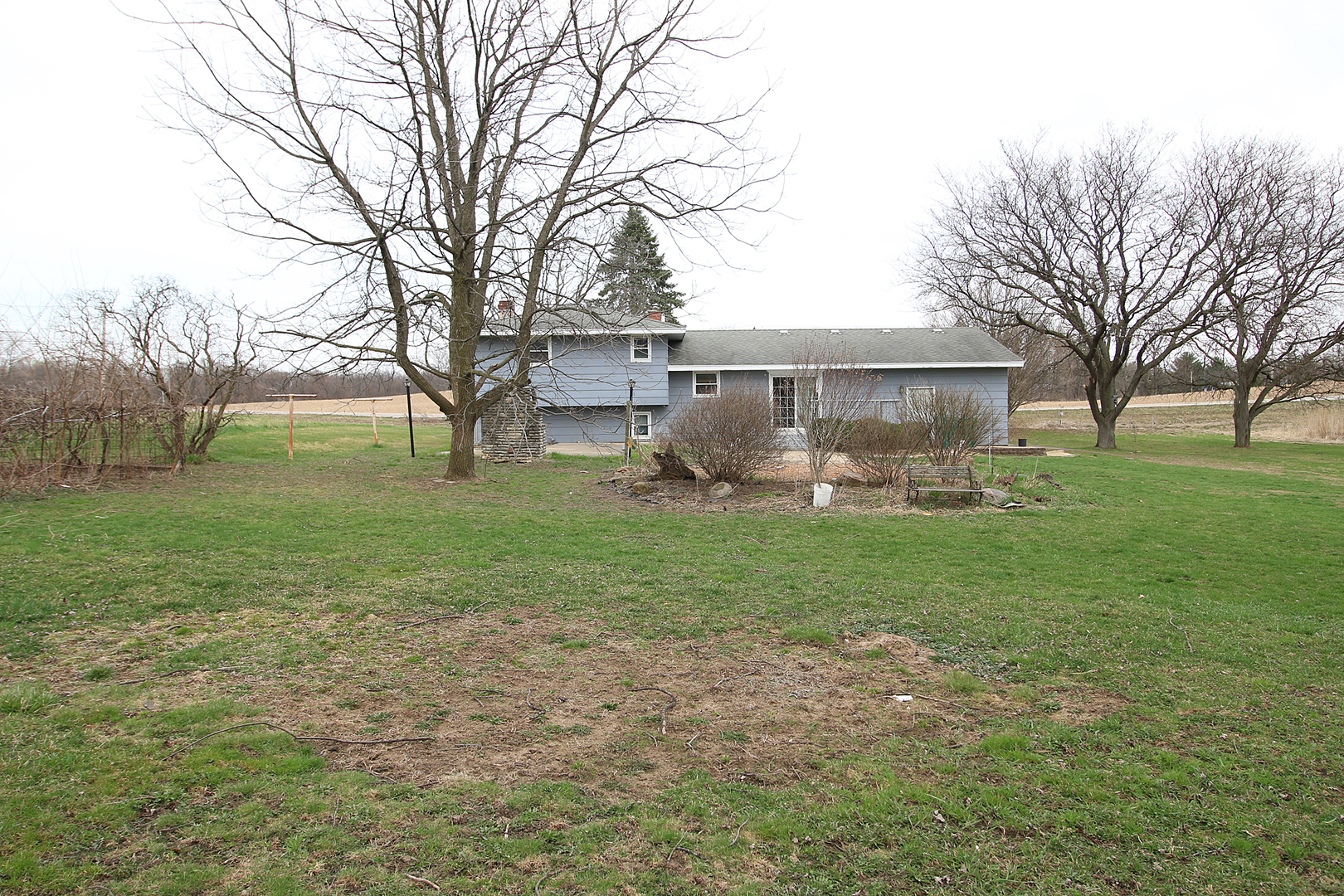 1356 Smith Road Lockport, IL 60441 - Photo 17 of 20 a front view of a house with garden and trees