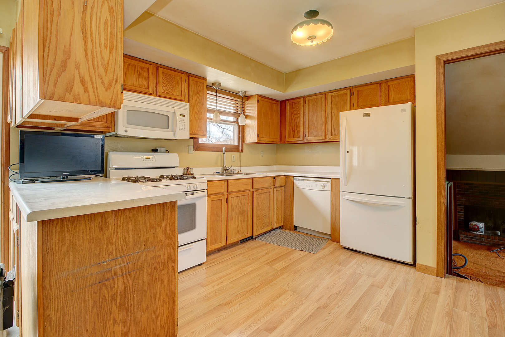 1356 Smith Road Lockport, IL 60441 - Photo 7 of 20 a kitchen with a refrigerator a stove a sink dishwasher and wooden cabinets with wooden floor
