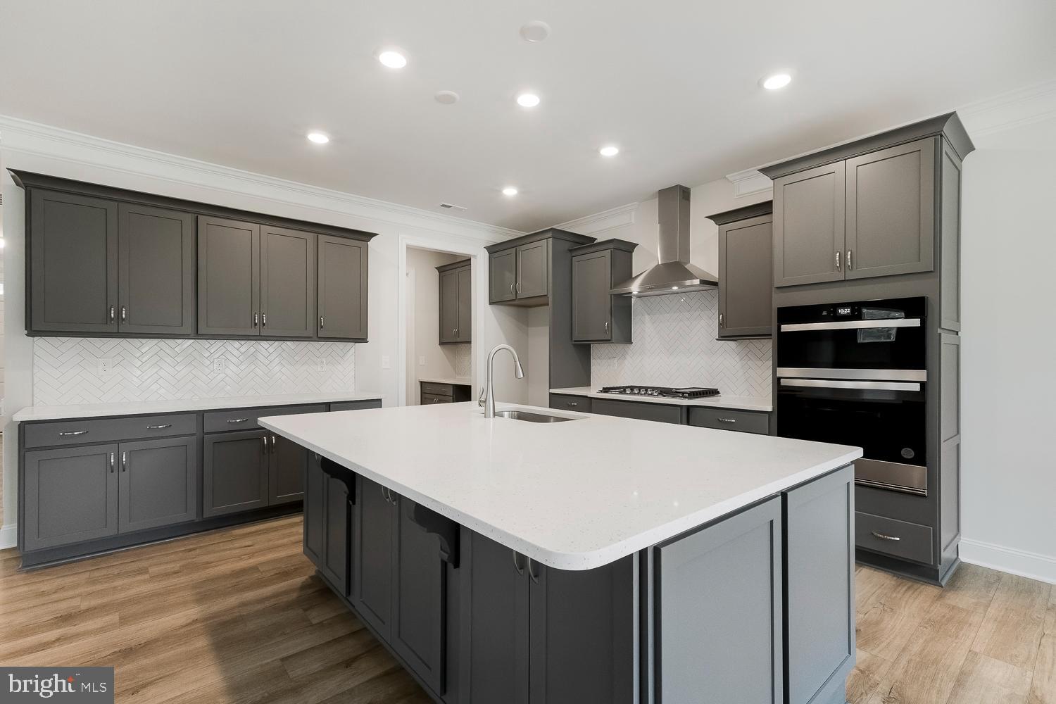 3186 Three Chopt Road Gum Spring, VA 23065 - Photo 2 of 11 a kitchen with a sink a stove a refrigerator and cabinets