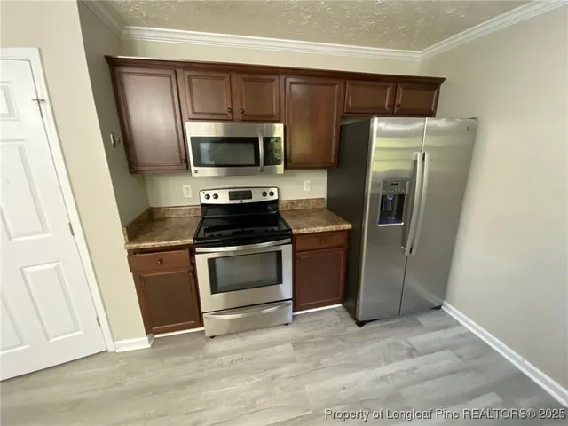 a kitchen with a refrigerator stove and microwave