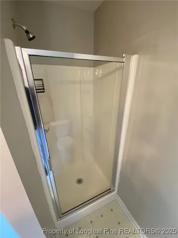 a bathroom with a glass shower door