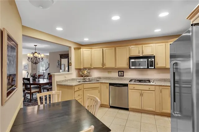 a kitchen with stainless steel appliances granite countertop a sink and cabinets