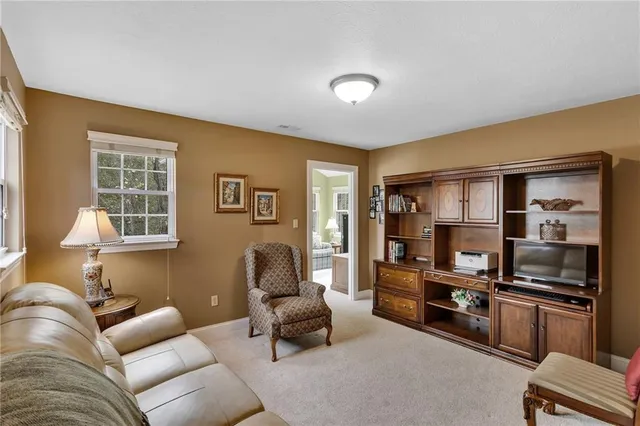 a living room with furniture fireplace and cabinets
