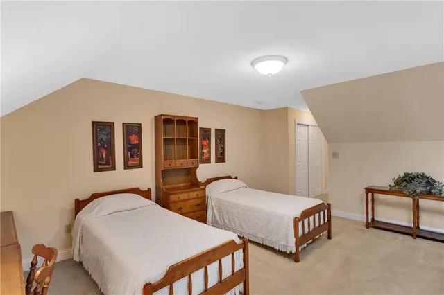 a bedroom with two beds and painted walls