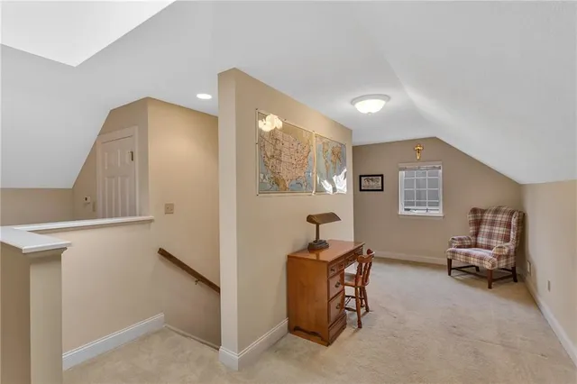 a view of a hallway with workspace and a window