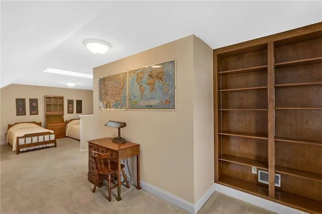 a living room with furniture a air conditioner and a window