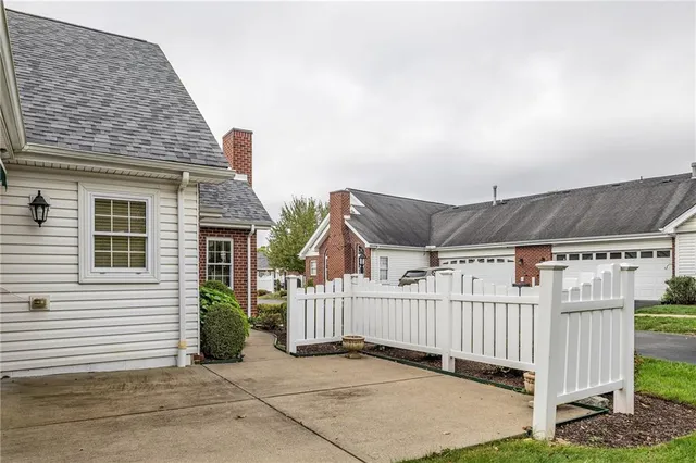 a view of a house with wooden fence