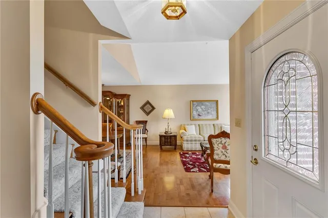 a view of entryway and hall with wooden floor