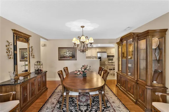a view of a dining room with furniture and a chandelier