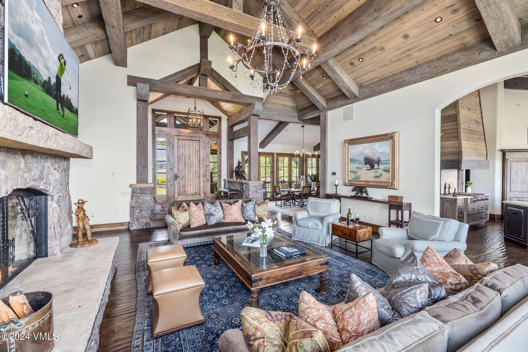 76 Setting Sun Lane Wolcott, CO 81655 - Photo 19 of 79 a living room with furniture a fireplace and a chandelier
