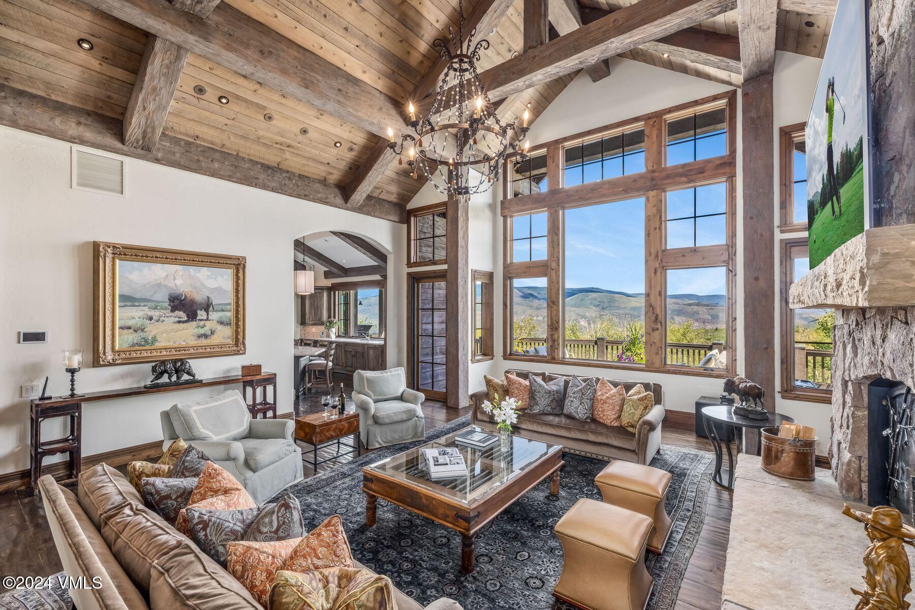 76 Setting Sun Lane Wolcott, CO 81655 - Photo 20 of 79 a living room with furniture a flat screen tv and a large window