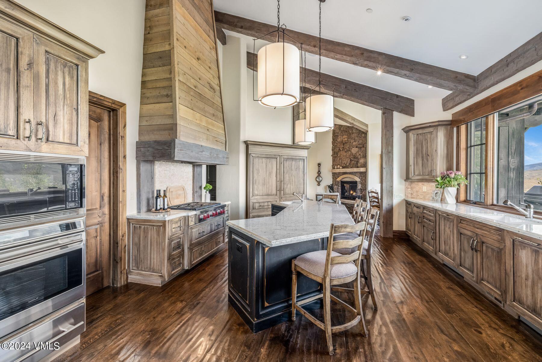 76 Setting Sun Lane Wolcott, CO 81655 - Photo 28 of 79 a kitchen with stainless steel appliances granite countertop a stove a refrigerator and a stove with wooden floors
