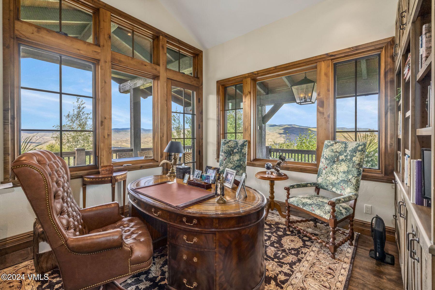 76 Setting Sun Lane Wolcott, CO 81655 - Photo 45 of 79 a dining room with furniture a large window and a chandelier
