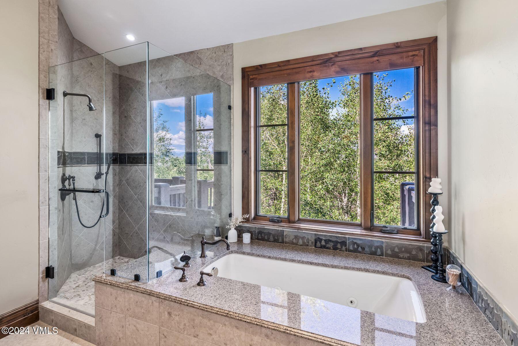 76 Setting Sun Lane Wolcott, CO 81655 - Photo 50 of 79 a bathroom with a granite countertop tub sink and mirror