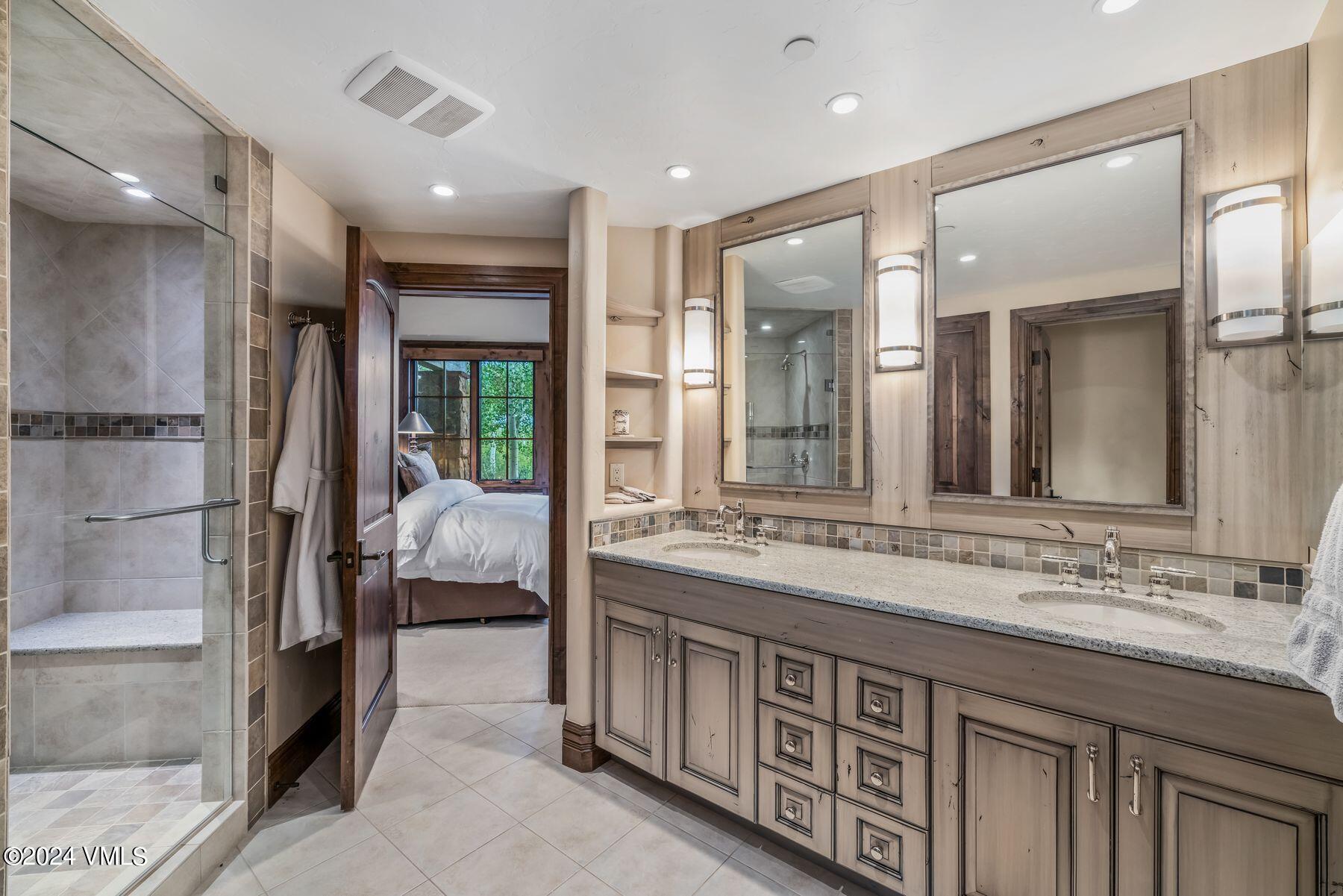 76 Setting Sun Lane Wolcott, CO 81655 - Photo 60 of 79 a bathroom with a double vanity sink and a mirror