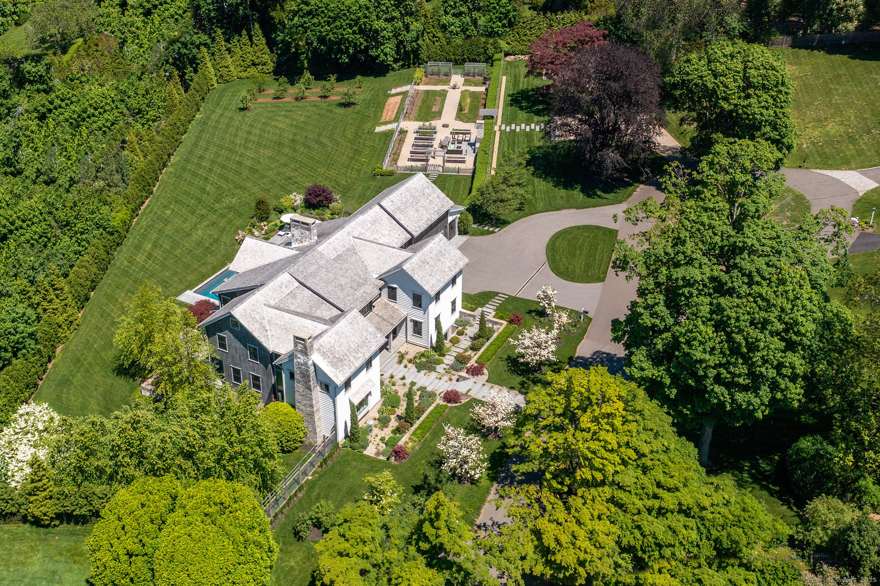 an aerial view of a house with a garden