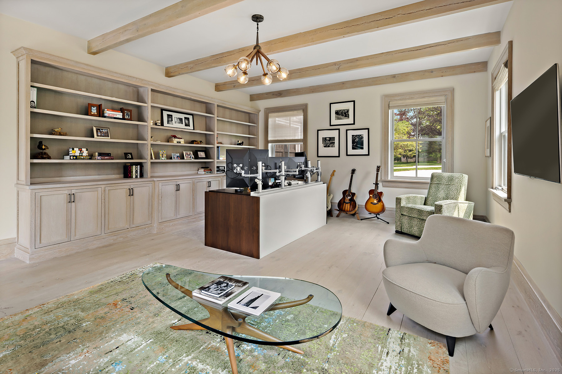 39 Compo Parkway Westport, CT 06880 - Photo 15 of 40 a living room with furniture a chandelier and a flat screen tv