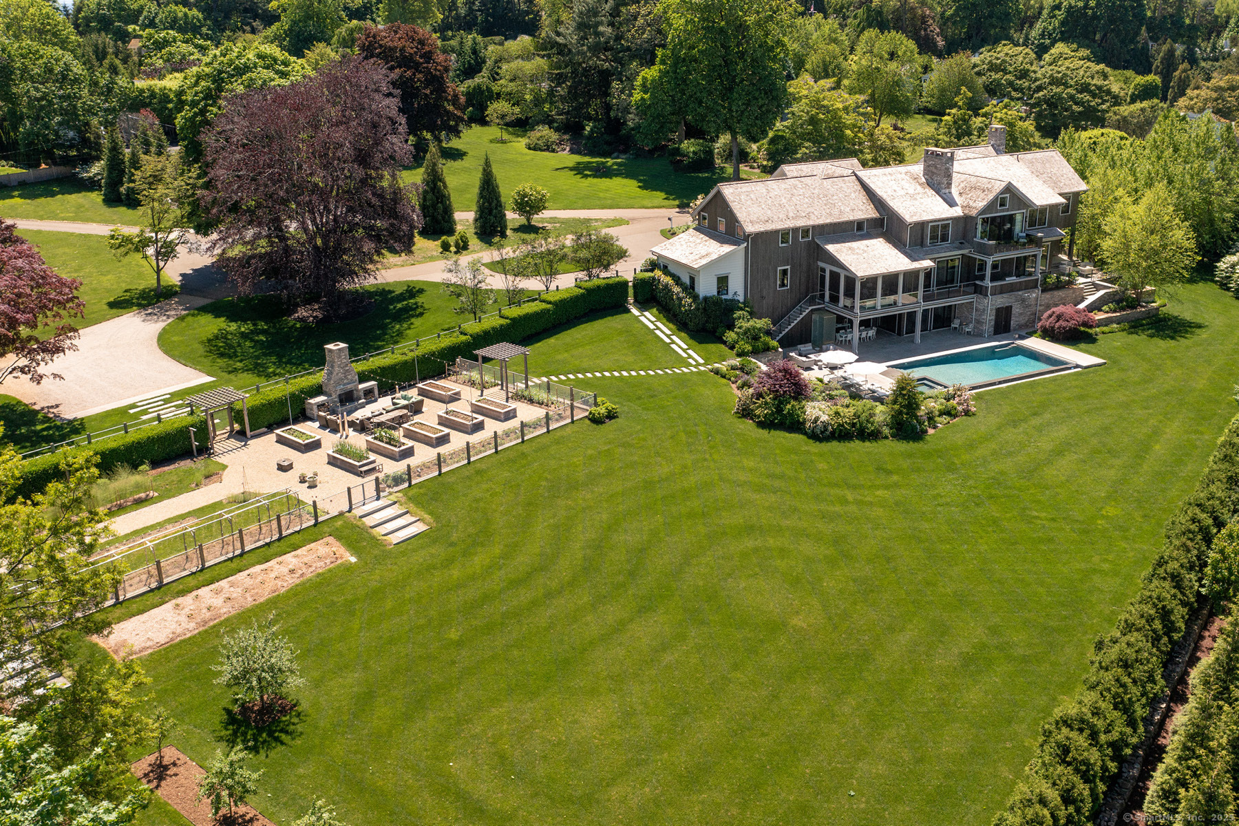 39 Compo Parkway Westport, CT 06880 - Photo 2 of 40 an aerial view of a house with a garden and swimming pool