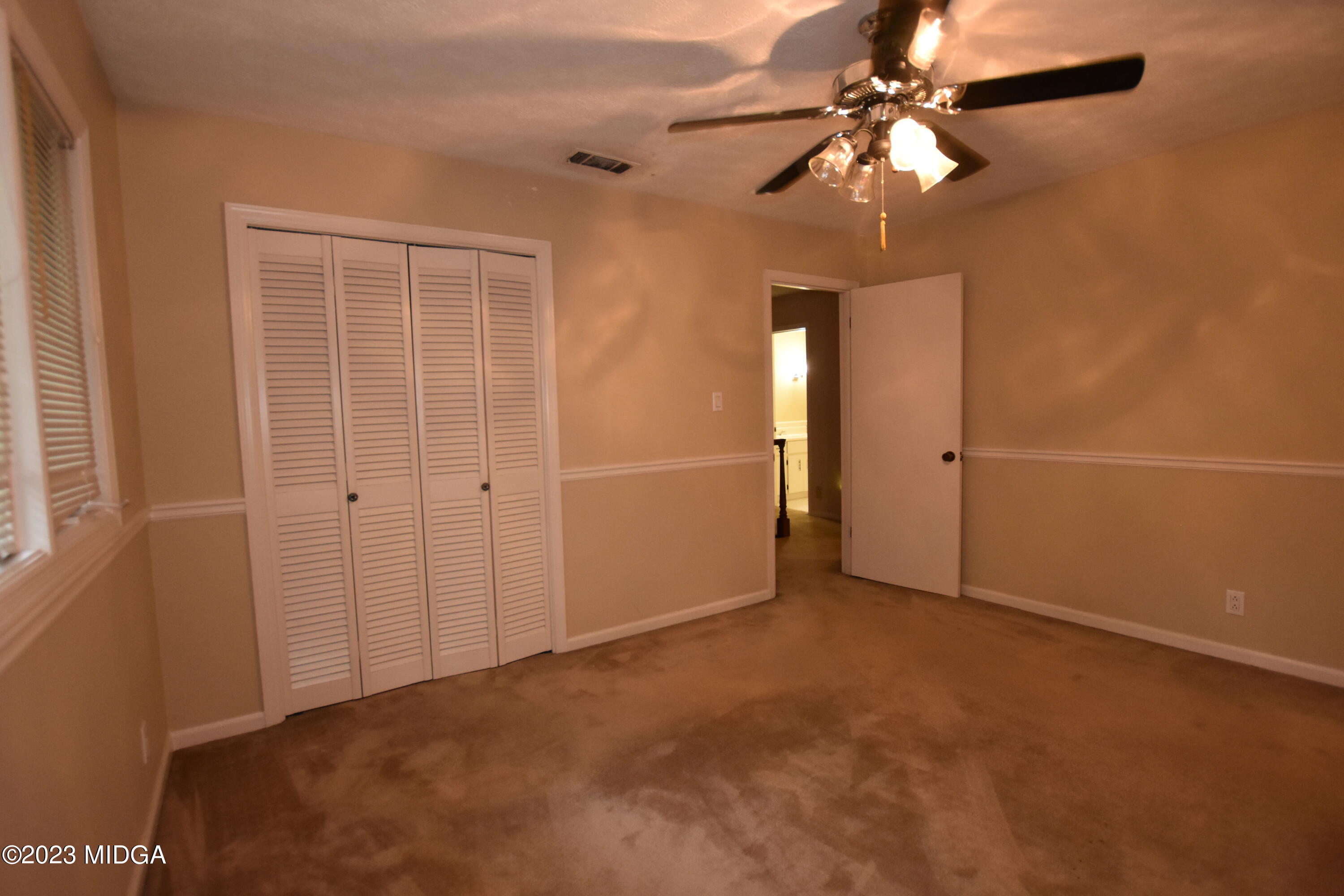 2994 Rolling Road Macon, GA 31204 - Photo 19 of 27 an empty room with closet and a chandelier fan