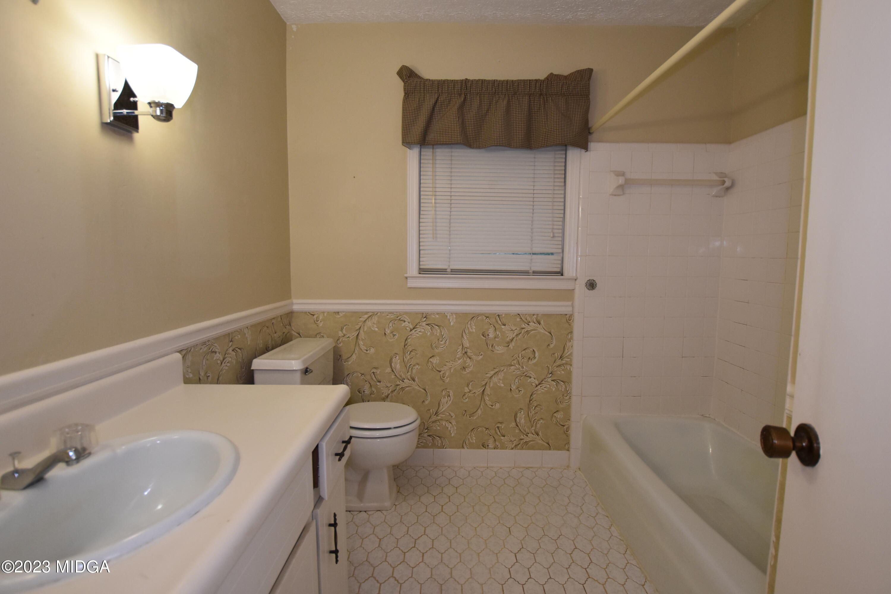 2994 Rolling Road Macon, GA 31204 - Photo 20 of 27 a bathroom with a sink a toilet and shower