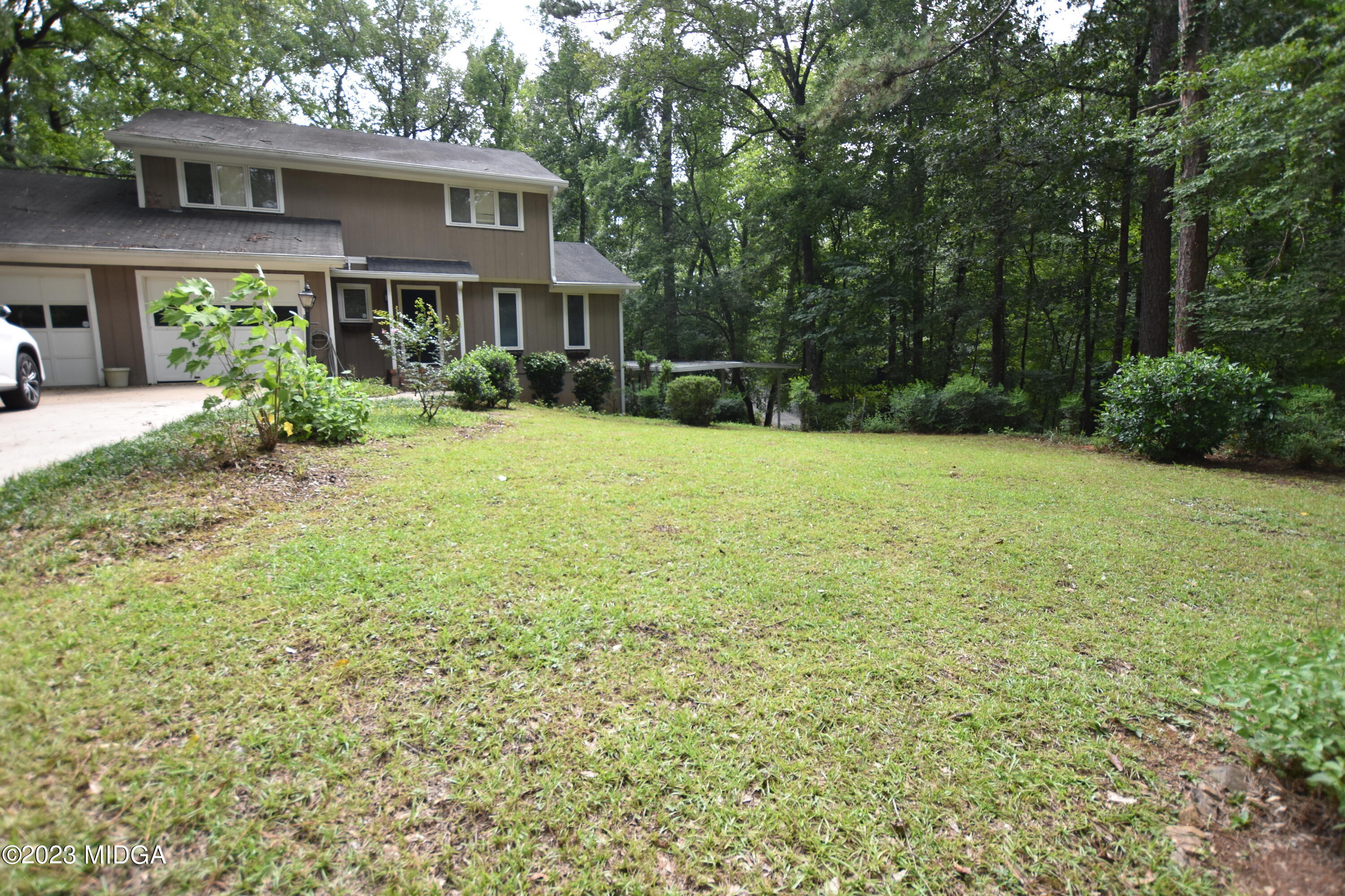 2994 Rolling Road Macon, GA 31204 - Photo 2 of 27 a house with huge green field in front of it