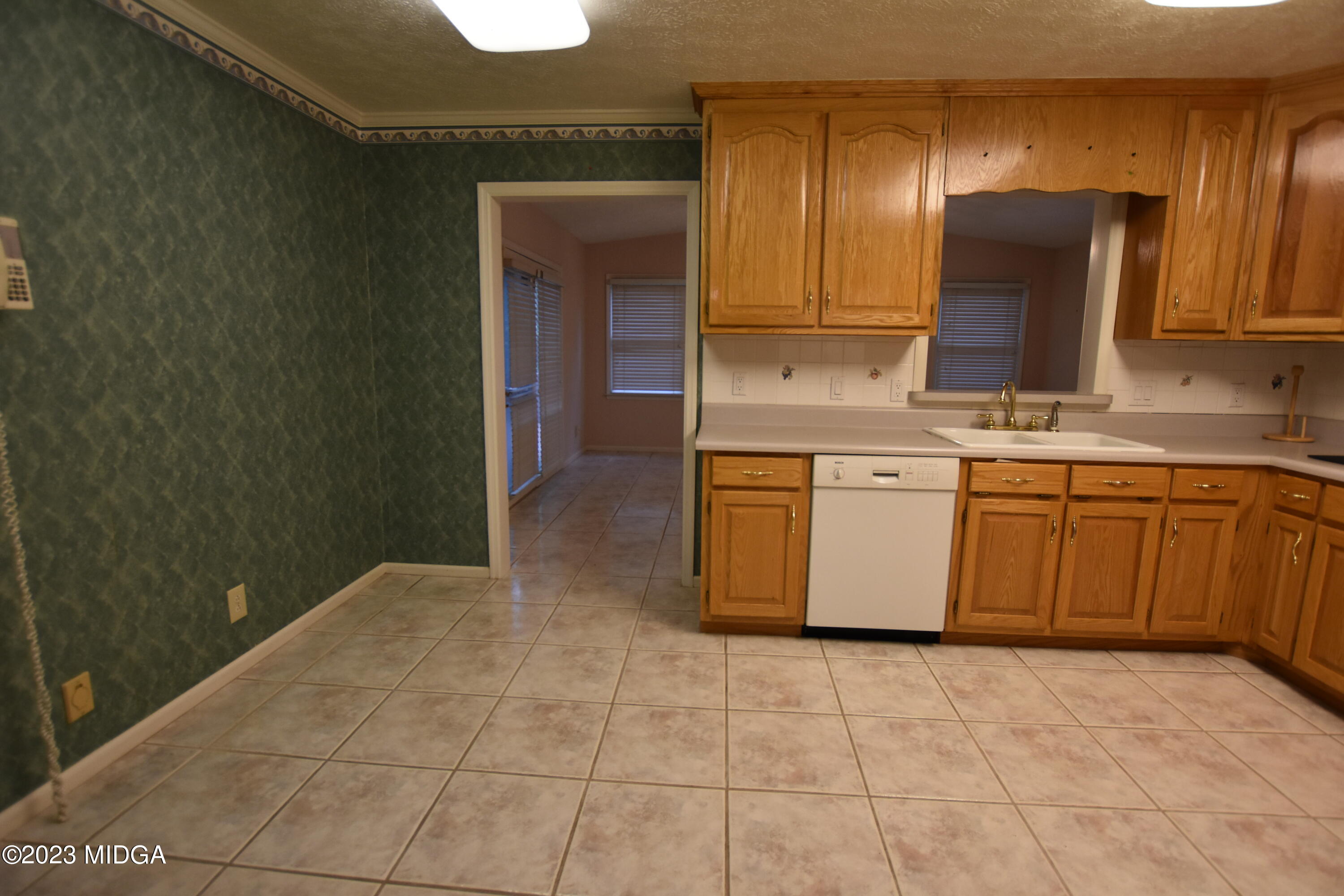 2994 Rolling Road Macon, GA 31204 - Photo 21 of 27 a kitchen with stainless steel appliances granite countertop a stove a sink and a refrigerator