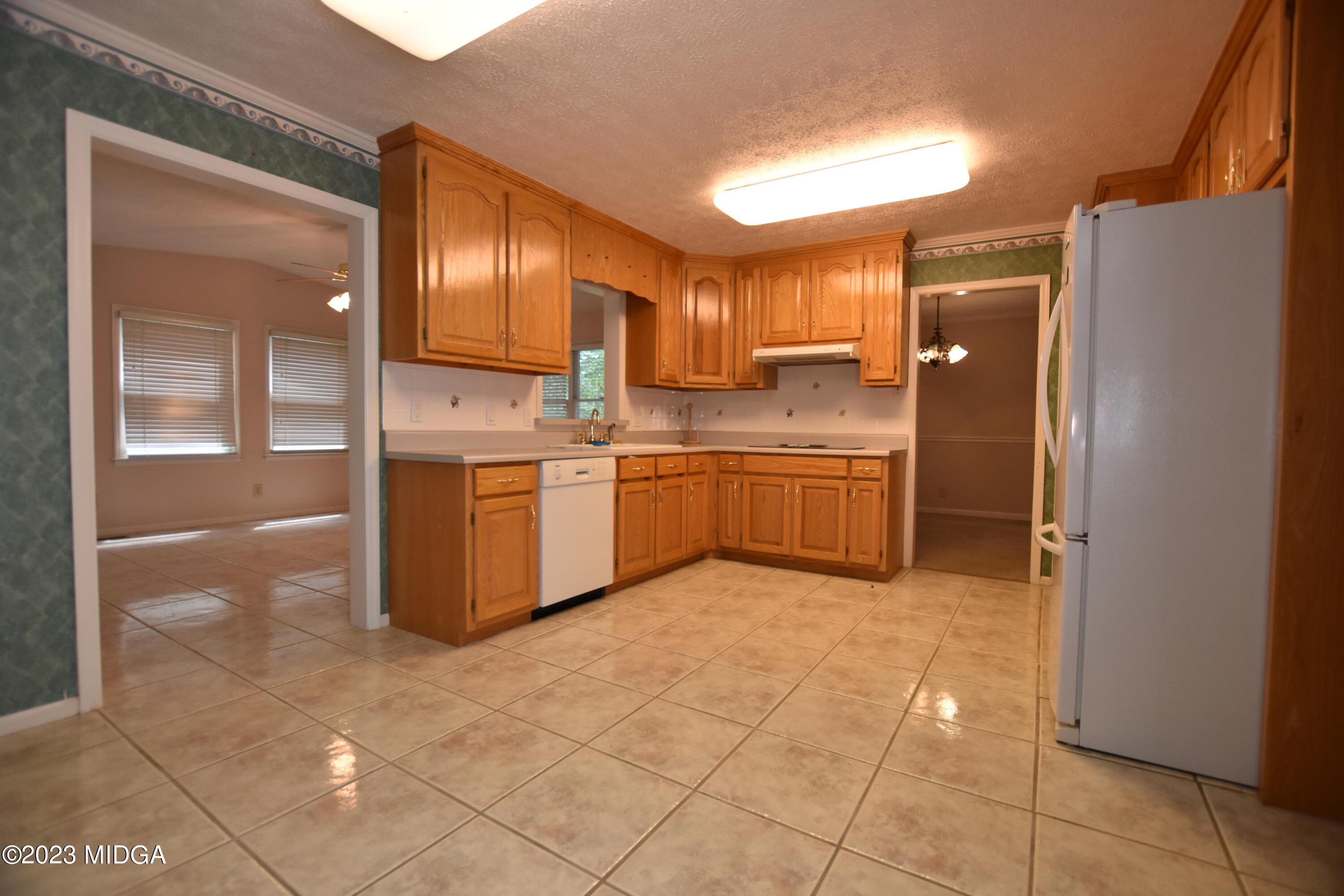 2994 Rolling Road Macon, GA 31204 - Photo 9 of 27 a kitchen with stainless steel appliances granite countertop a refrigerator and a sink