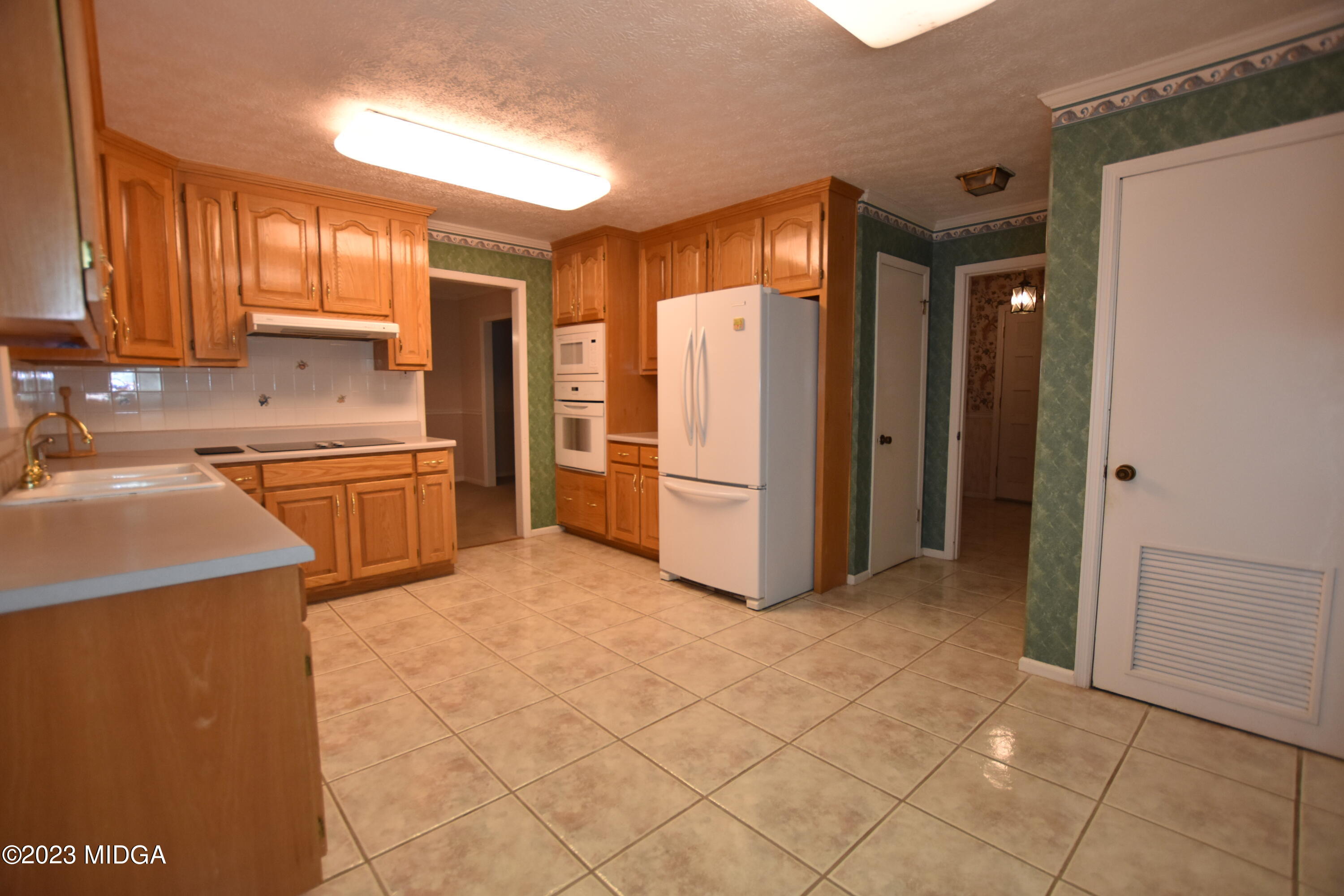 2994 Rolling Road Macon, GA 31204 - Photo 10 of 27 a kitchen with stainless steel appliances granite countertop a refrigerator and a sink