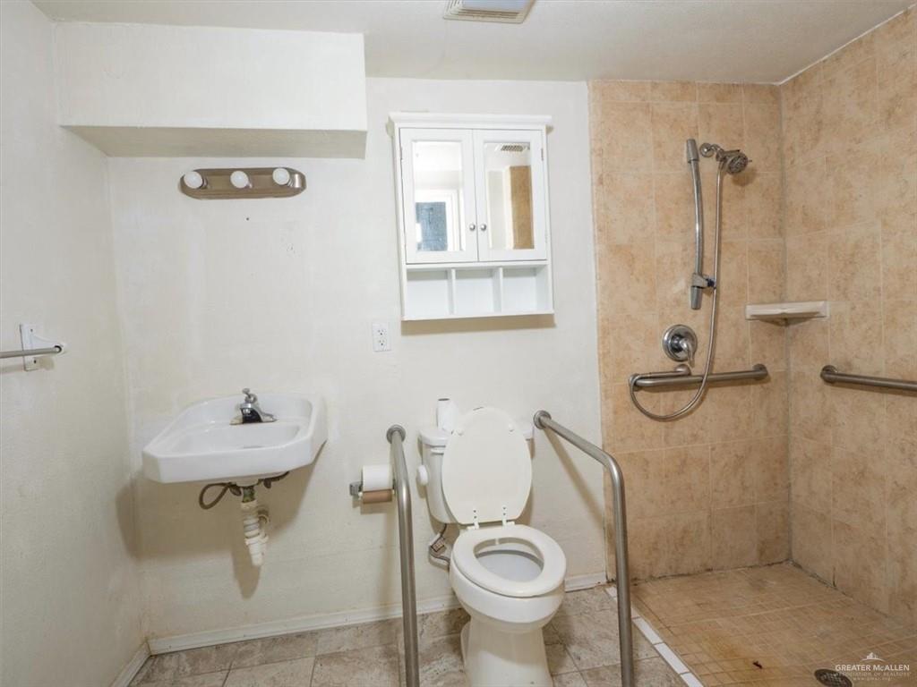 23067 Cragon Road Harlingen, TX 78552 - Photo 15 of 28 a bathroom with a sink toilet and shower