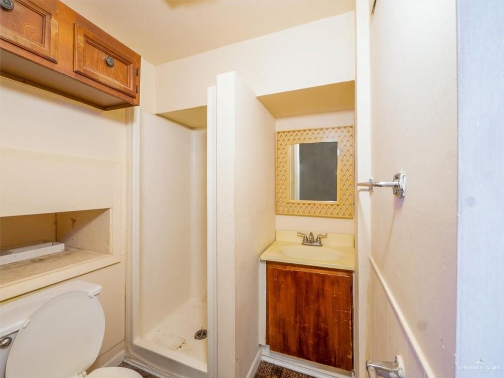 23067 Cragon Road Harlingen, TX 78552 - Photo 21 of 28 a bathroom with a sink a toilet and shower