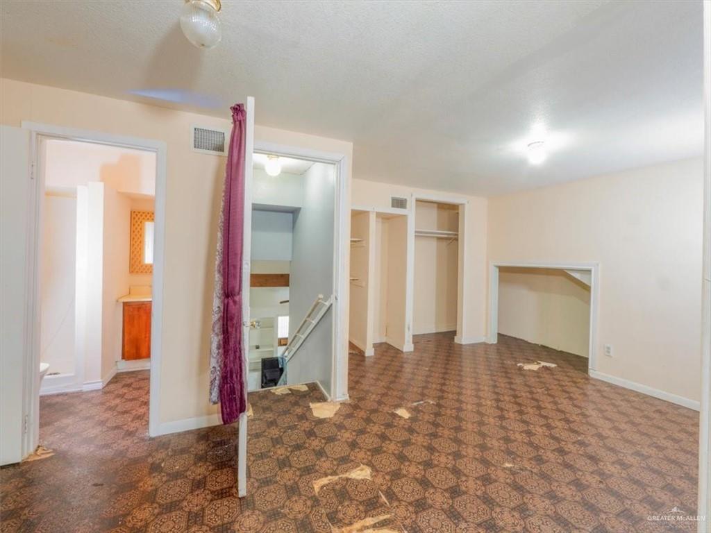 23067 Cragon Road Harlingen, TX 78552 - Photo 23 of 28 a view of a hallway with wooden floor